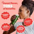 Woman drinking a green smoothie with health benefits text on a pink background