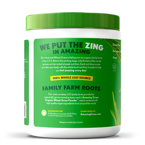 Green and white container of Amazing Grass wheat grass powder on a white background