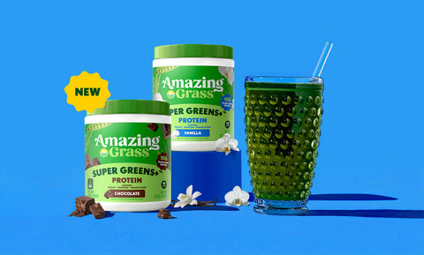 Two containers of Amazing Grass protein powder and a glass of green juice on a blue background.